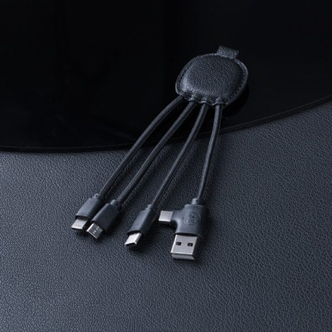 Black INÉ Smart with braided cables on a dark leather surface