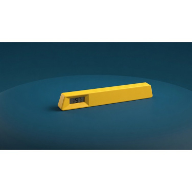 Yellow Xoopar Le19 digital room thermometer on a dark blue background