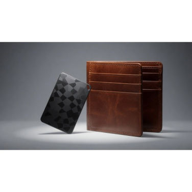 Black LITAII card tracker with geometric pattern next to a brown leather wallet