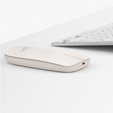 Speckled wheat-composite Pokket mouse on a white desk next to a keyboard