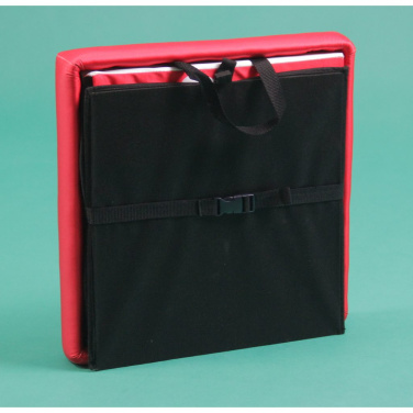 Folded advertising cube standing upright with carry handle and buckle strap